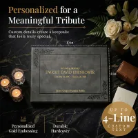 Personalized funeral guestbook with elegant gray hardcover and gold embossing, shown with candles and flowers, featuring custom text up to 4 lines—ideal keepsake for a meaningful tribute.