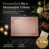 Personalized funeral guestbook in rose gold hardcover with gold embossing, shown with candles and flowers, featuring up to 4 lines of custom text for a meaningful tribute keepsake.