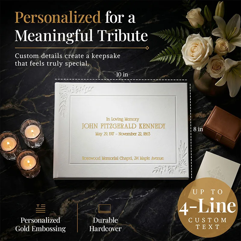 Personalized funeral guestbook in white hardcover with gold embossing, shown with candles and flowers, featuring up to 4 lines of custom text for a meaningful tribute keepsake.