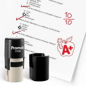 Black self inking teacher stamp and removable cap displayed beside a graded science worksheet marked with red check marks and a “10/10” score. A red apple stamp with a worm and “A+” design appears on the page, showing how the classroom stamp can reward ex