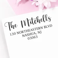 Personalized address stamp impression with The Mitchells return address on a white envelope