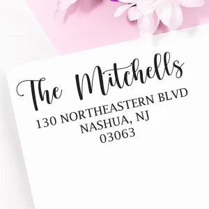 Extra large personalized address stamp impression with The Mitchells return address on a white envelope