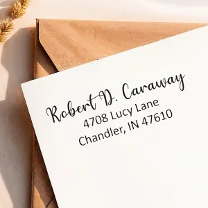 A crisp return address from a medium self-inking address stamp printed neatly on a white envelope.